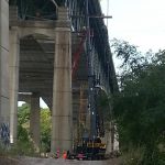 Picture of crane working under bridge on Interstate 90.
