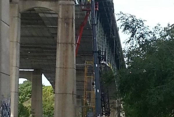 Picture of crane working under bridge on Interstate 90.