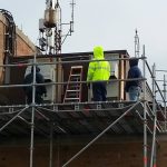 The building had multiple roof lines. The scaffold is built on top of the rooftop below. The scaffold stands about 20 feet.