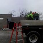 Unloading concrete plank off of the truck.