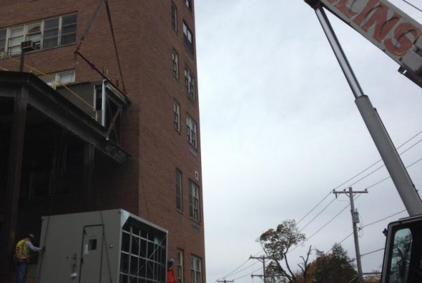 Setting a large indoor unit down inside a basement.