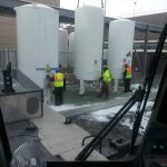 Setting tank on pad for final placement.