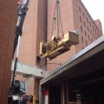 Hoisting one of the generatos out over the building.