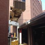 Hoisting one of four generators out of alley way with kevlar straps and chainfalls.