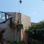 Working on taking the statue of the blessed mother off of the side of the building.