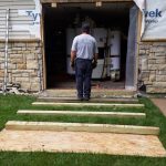 Laying wood out to level up with the floor in the building.