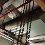 Chainfall hooked up to trolley hung from a beam in the ceiling is used for rigging.