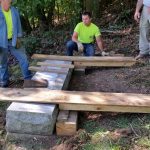 Laying wood out so we have a flat even surface to set the gravestone onto. This will help us stand it up later without damaging the stone.