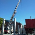Using our 65 ton crane to set pre-cast concrete walkway and bleachers for a high school stadium.
