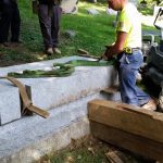 We rig the gravestone now so that it will stand up straight when we pick it up.