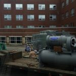 Unloading chiller we hauled to site.
