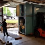 Using a forklift to bring the washing machine outside.