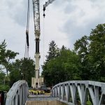 Reaching out and setting the floor beams. Each floor beam weighed 3,500 lbs.