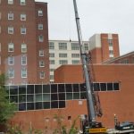 Lifting pieces and installing units into a penthouse.