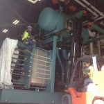 Using our hydraulic jacking system to lower the chiller down to the pad.