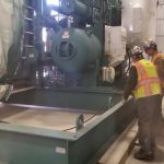 Using our hydraulic jacking system to lower the chiller down to the pad.