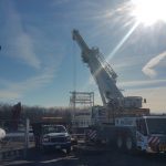 Setting a concrete vault with our 220 ton crane.