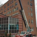 Coned off for safety. The crane is the perfect size to get the job done and keep the emergency ramp open for the ambulances and police officers.
