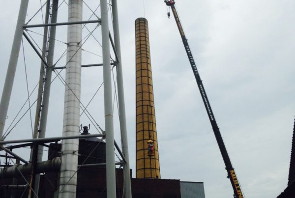 Lifting men in a man basket in Green Island, NY to inspect a smoke stack.