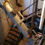 Using chainfalls to lower one end of the chiller into the room. It needed to be brought in this way because it