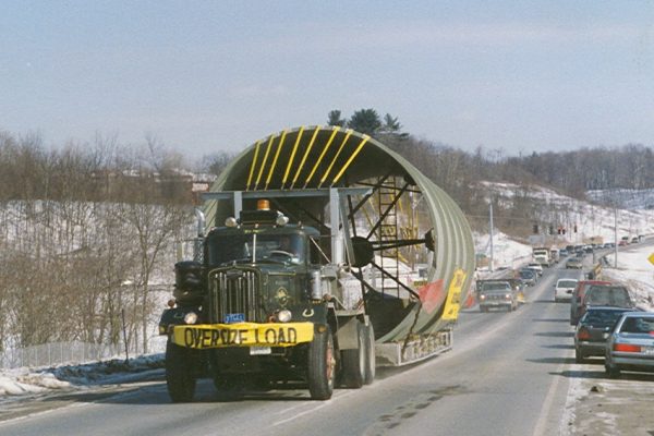 Mullins Rigging loaded transport smoke sections from Troy Boiler Works to general electric plant- Selkirk N.Y.- Special trailer deck designed and fabricated by Mullins to accommodate large diameter stacks (17 foot diameter) for road movement.