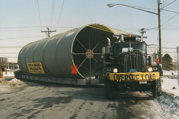 Mullins Rigging loaded transport smoke sections from Troy Boiler Works to general electric plant- Selkirk N.Y.- Special trailer deck designed and fabricated by Mullins to accommodate large diameter stacks (17 foot diameter) for road movement.