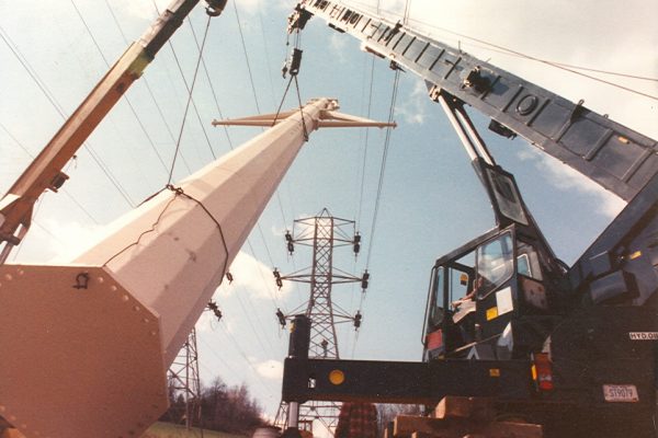 Mullins Rigging raising of power pole between energized electrical lines