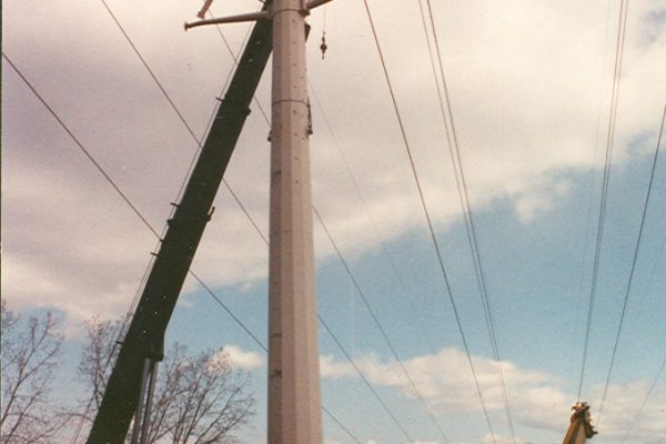 Mullins Rigging raising of power pole between energized electrical lines